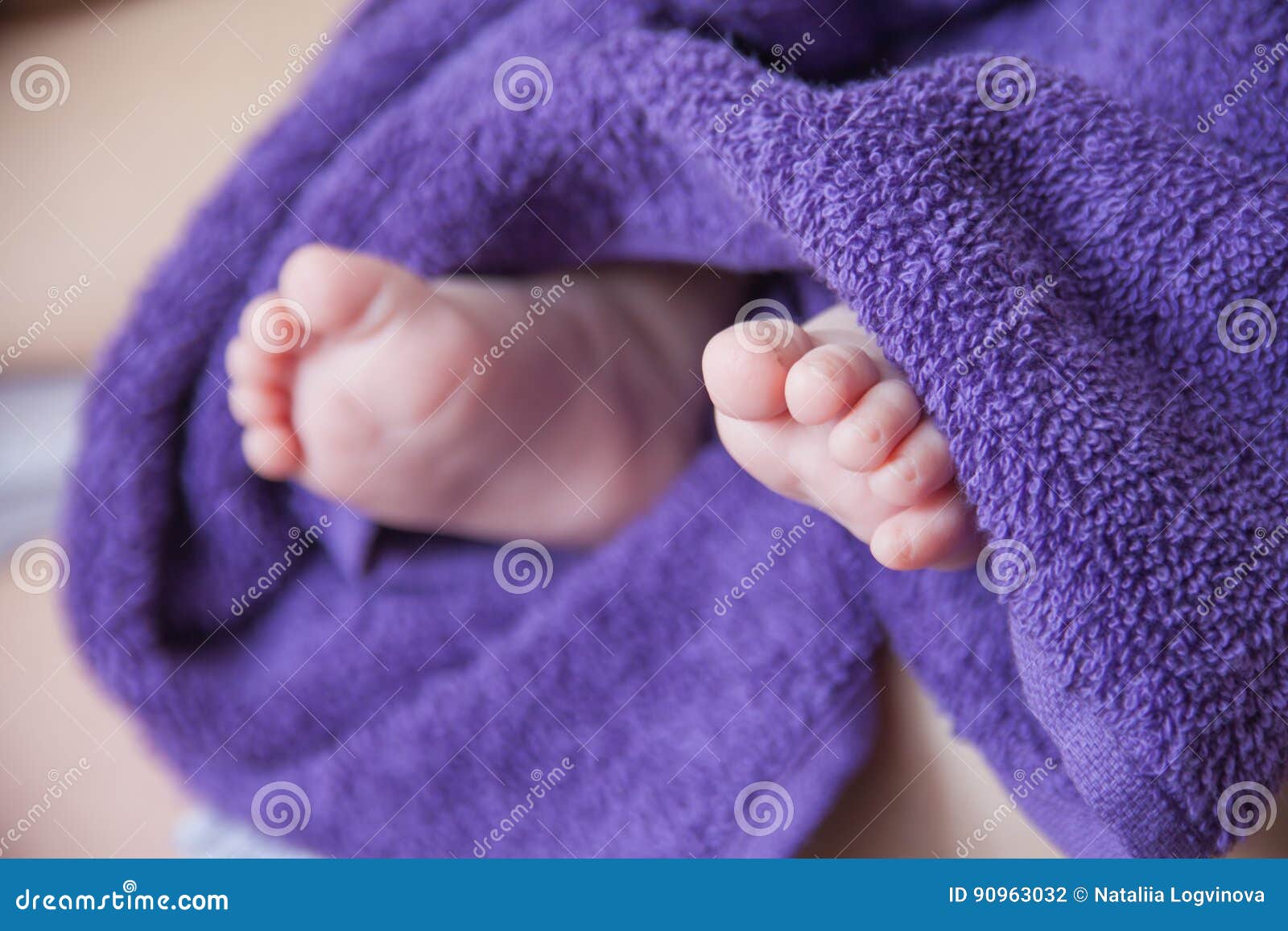 Baby feet in purple towel stock photo. Image of bright 90963032