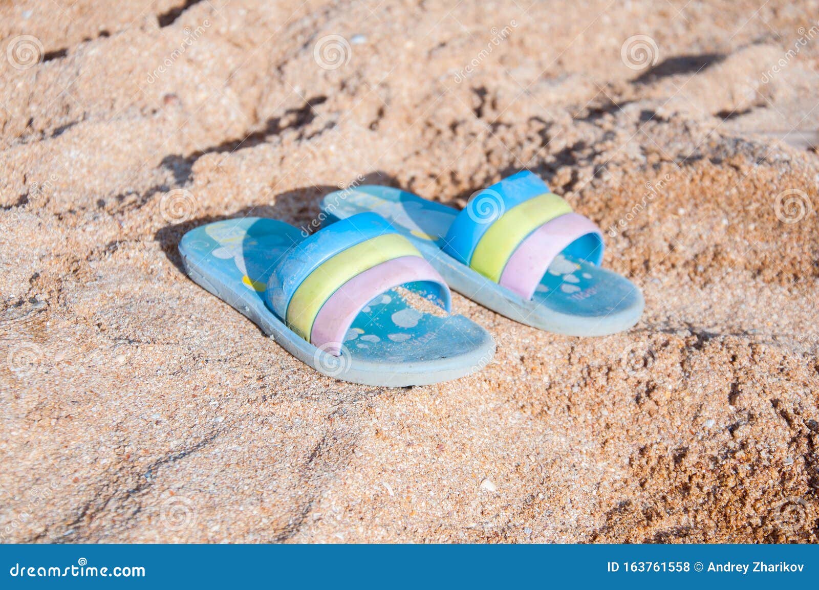 Baby Flip Flops in the Sand on the Beach. White Sand Near the Sea Stock ...