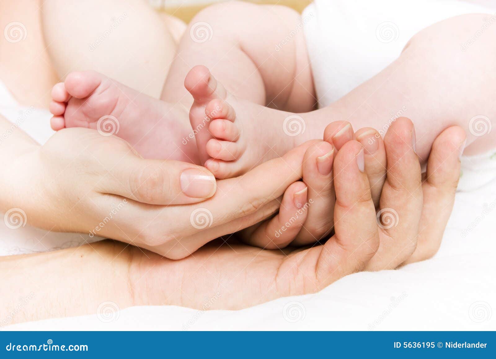 baby foots in hands of parents