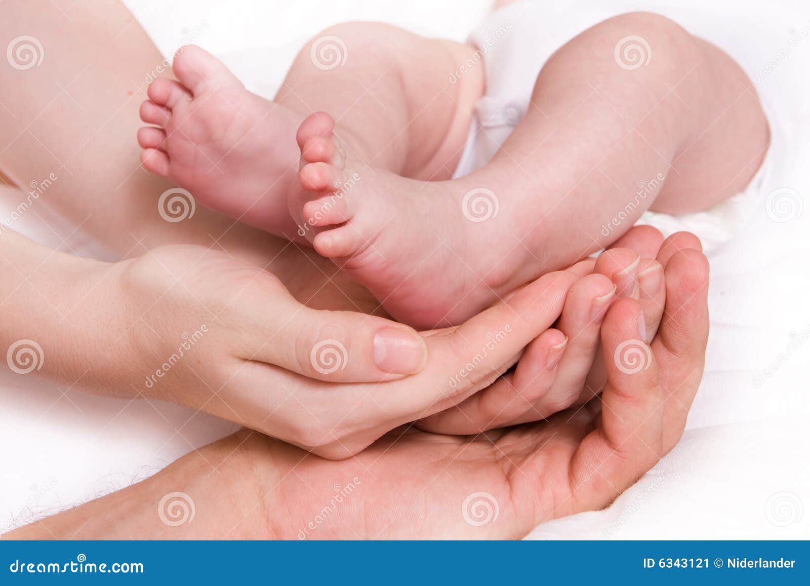 baby foots in hands of parents