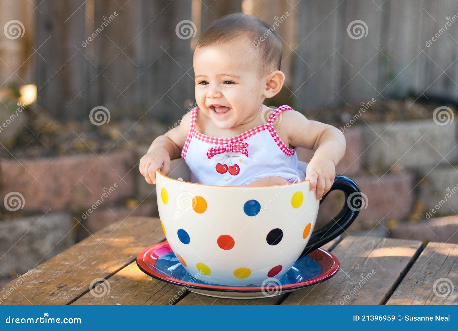 baby girl in giant teacup