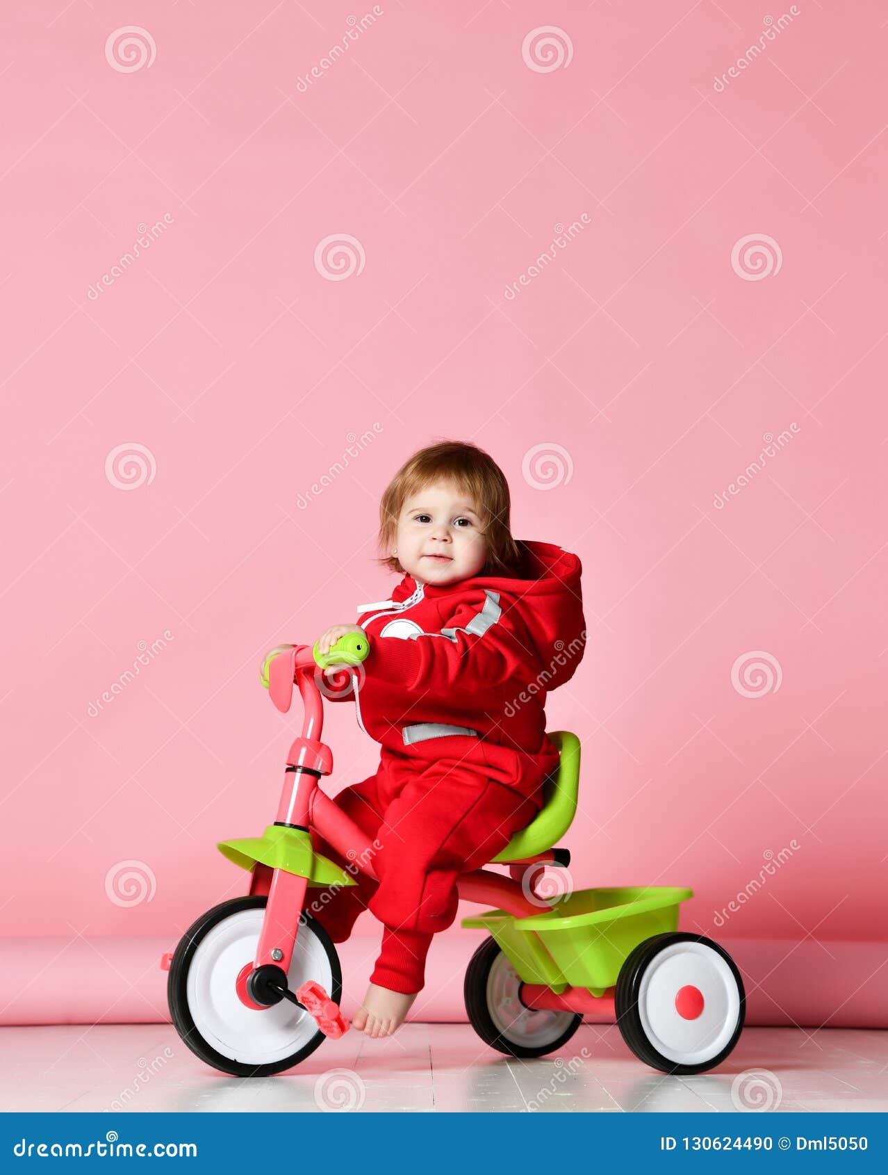 Baby Girl Kid Riding Her First Bicycle Tricycle In Red