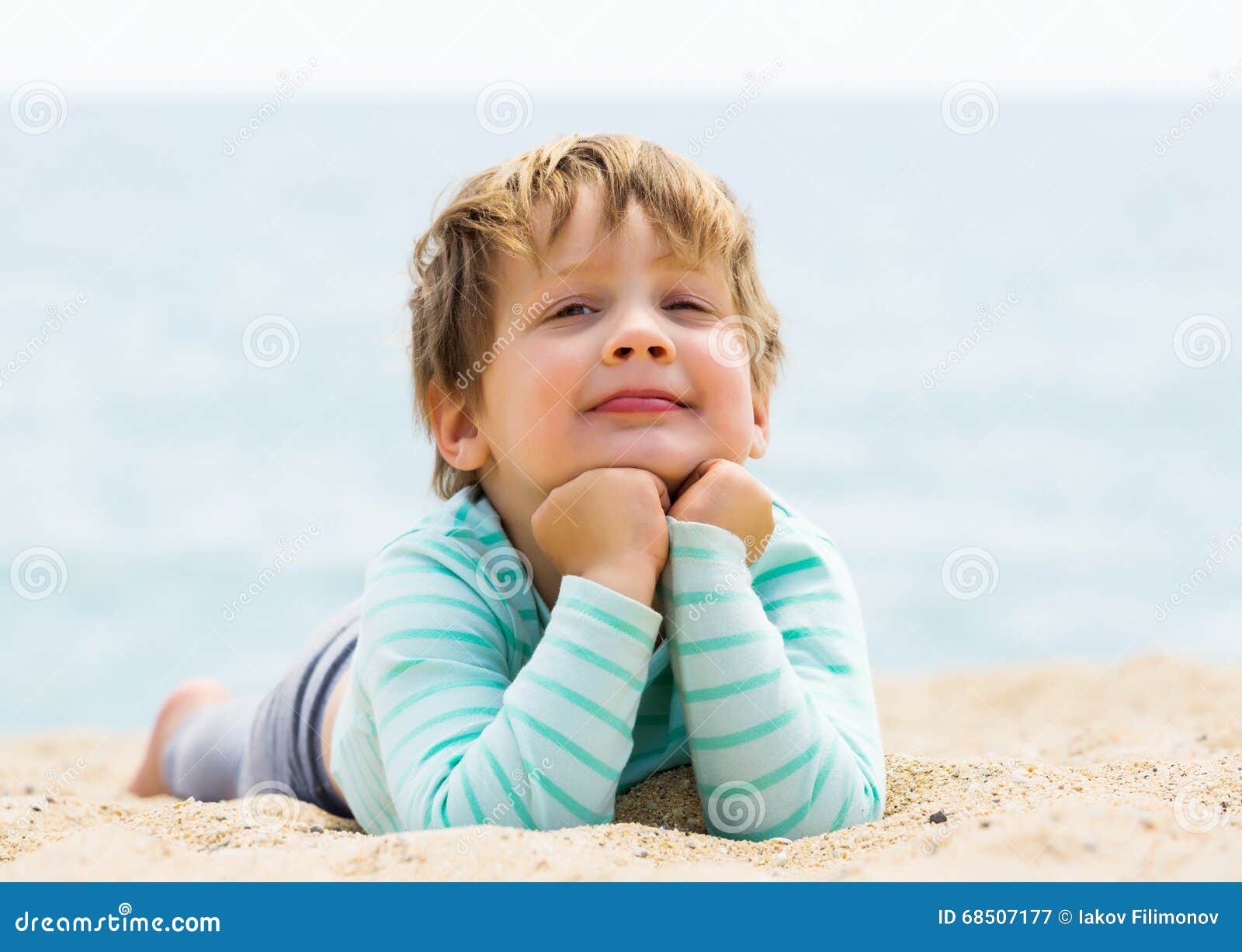 Baby girl laying on beach stock image. Image of happy 68507177