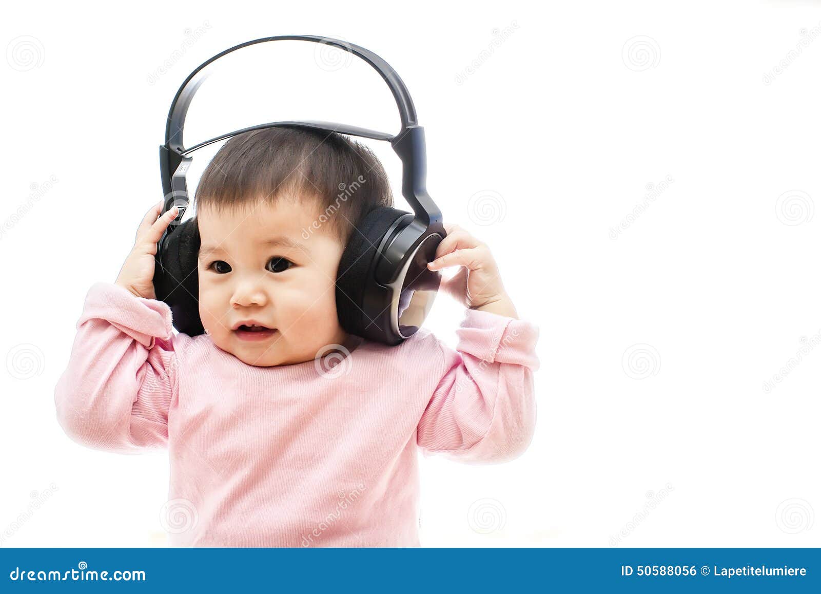 A Baby Girl Listens Music with Headphone with Hands Stock Photo - Image ...