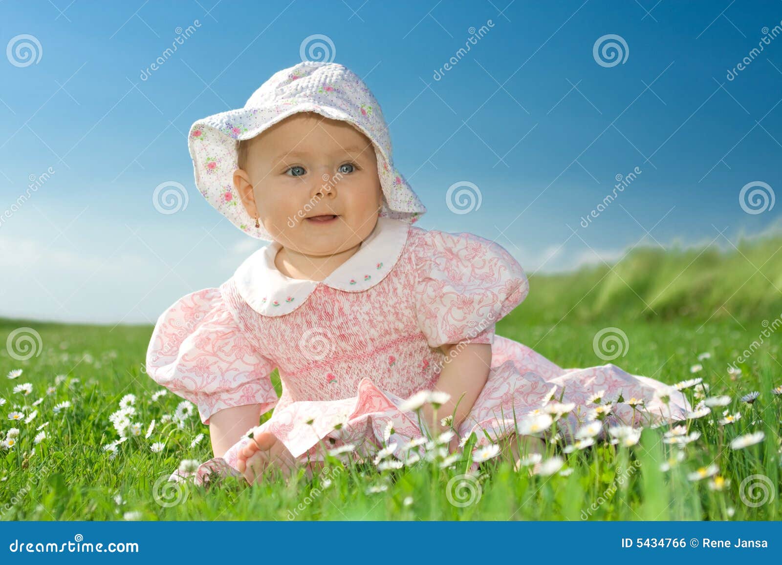 baby girl sat in flowery field