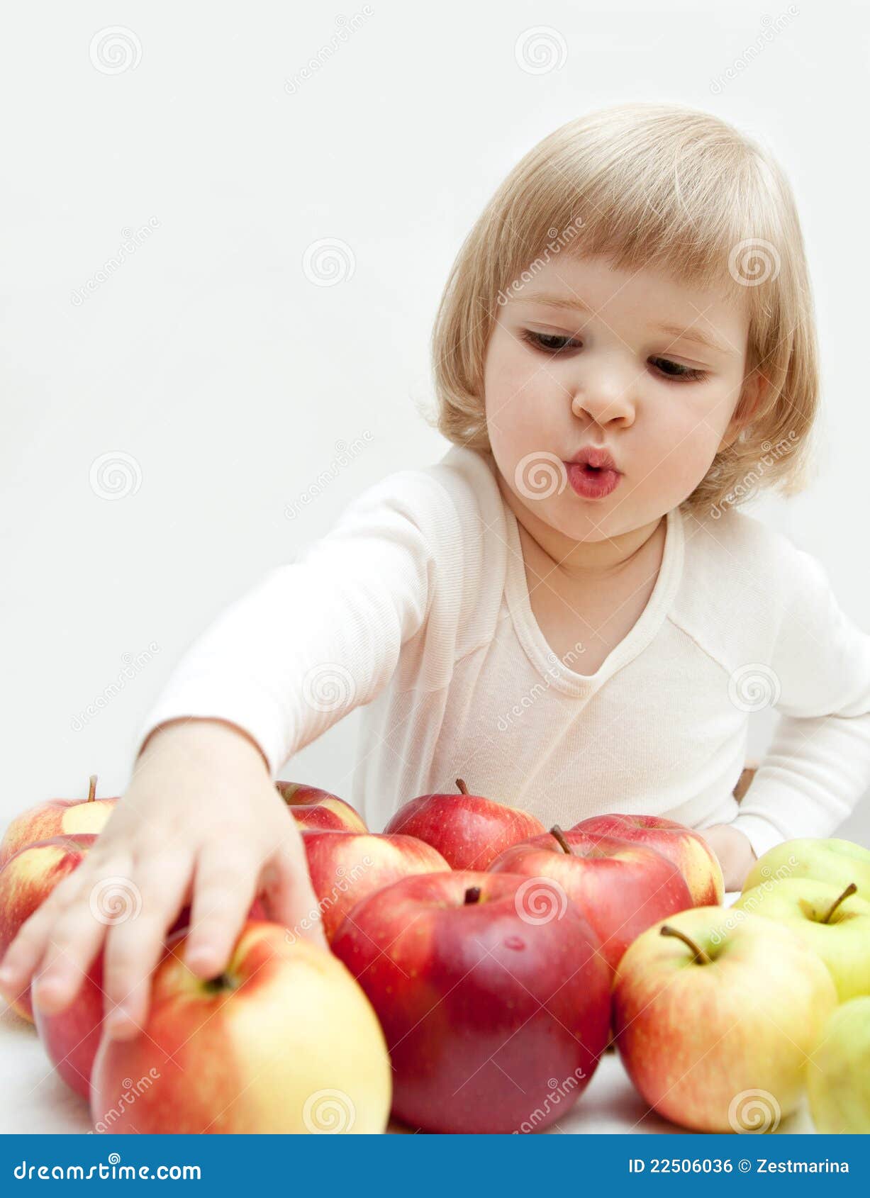 The Baby Girl is Selecting a Red Apple Stock Photo Image of white