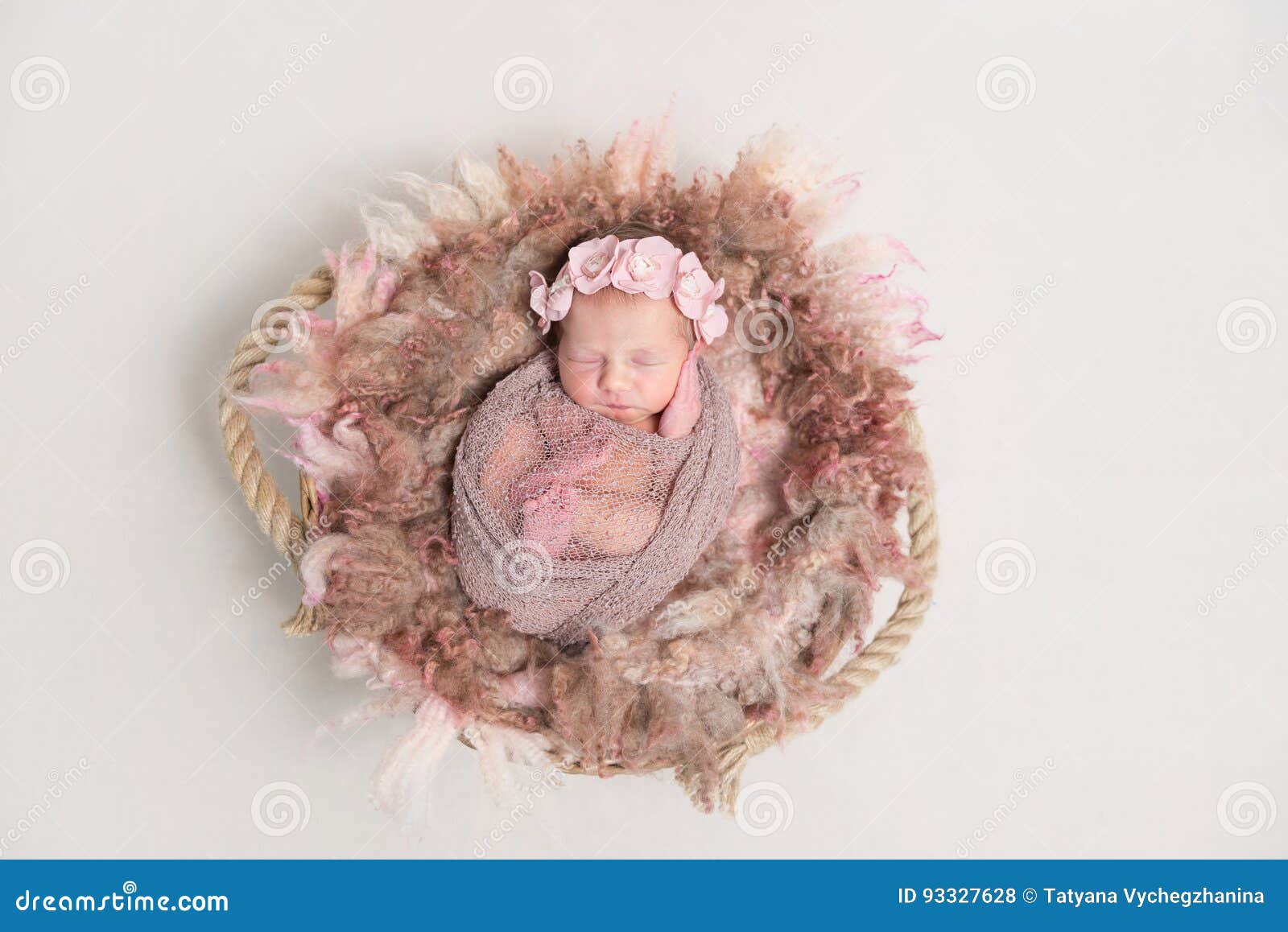 baby in hairband, wrapped in scarf, topview