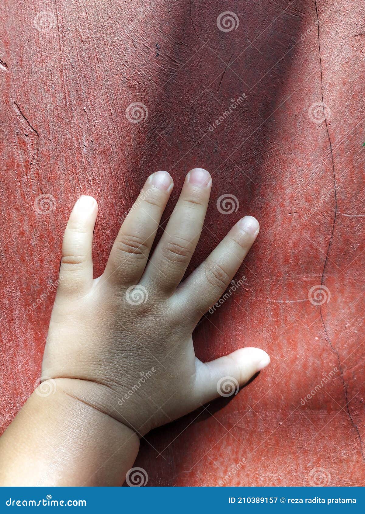 Baby hand on the red wall stock image. Image of hand 210389157