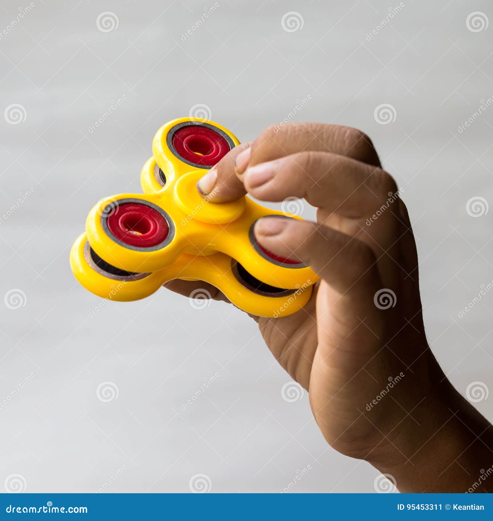 Baby Hand with Yellow Spinner. Stock Image - Image of hand, hobby