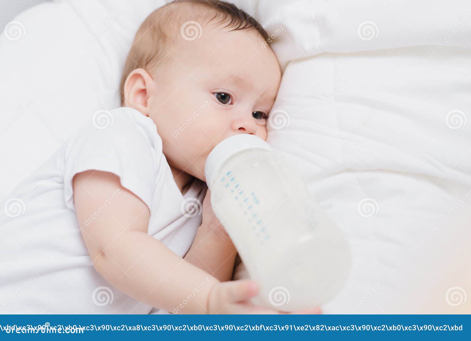 The Baby in His Crib Eats from a Bottle . Baby Food Copyspace