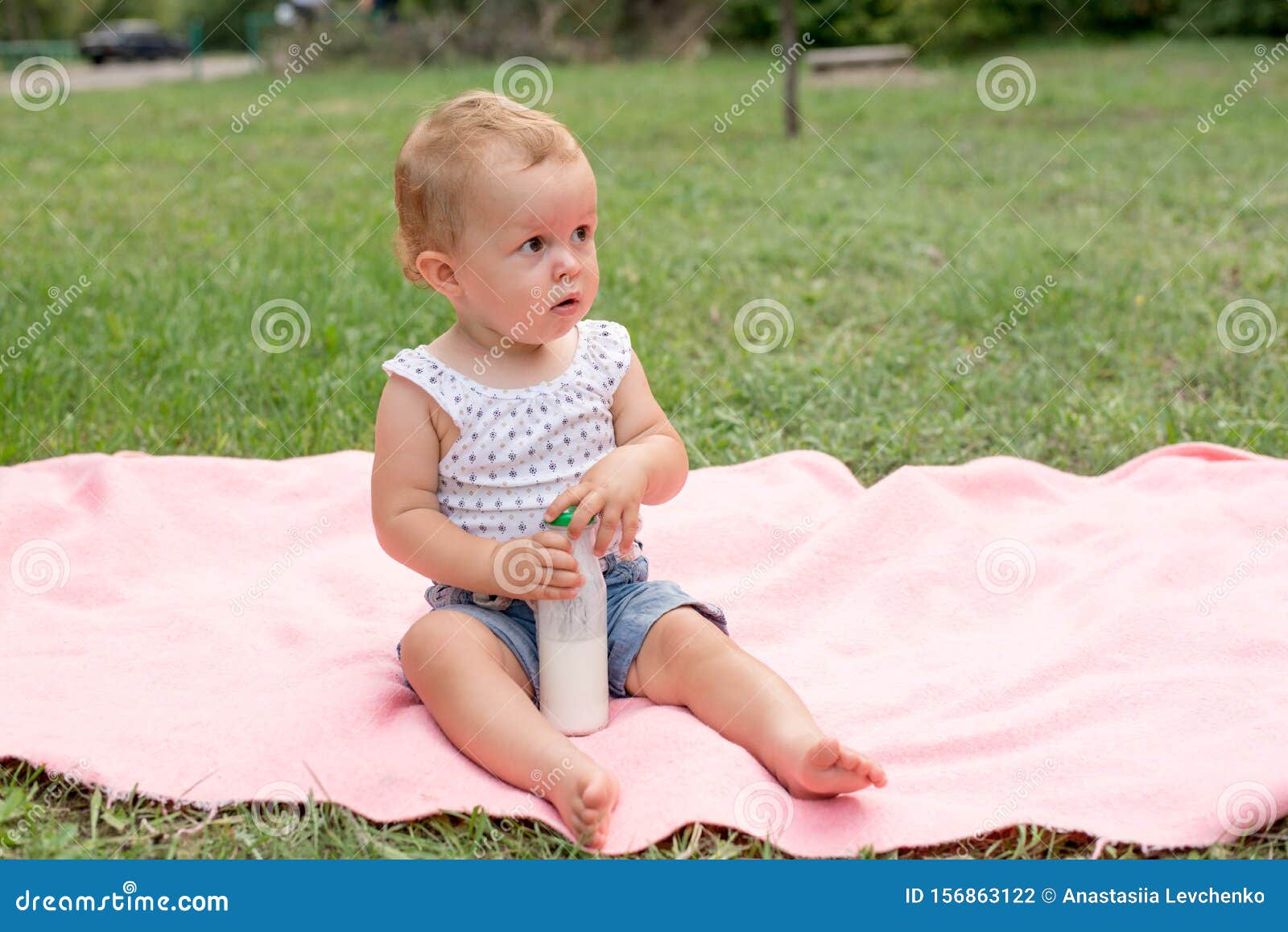 Baby Holding Bottle With Milk Or Kefir, Kid In The Park On ...