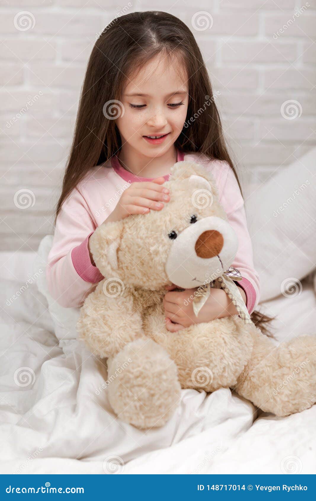 Baby hugging a teddy bear stock photo. Image of bedding - 148717014