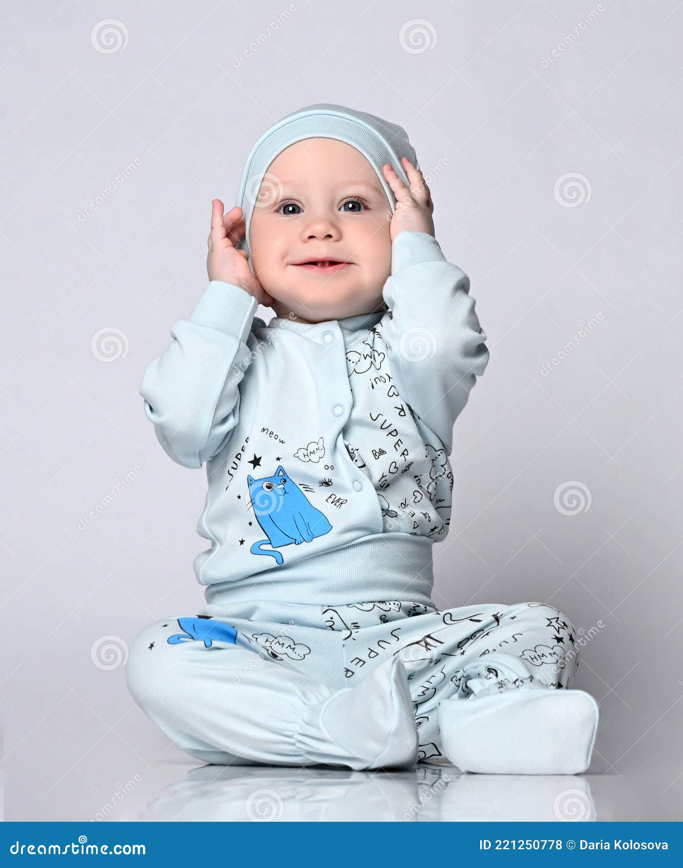 Baby Infant in a Body with Long Sleeves and a Shianishka, a Matching Hat,  with a Funny Childish Pattern on His Clothes Stock Photo - Image of  watching, bodysuit: 221250778