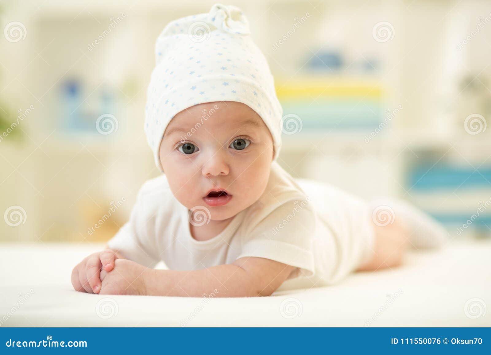 Baby Lying on Soft Bed Cover with Cap Stock Photo Image of funny