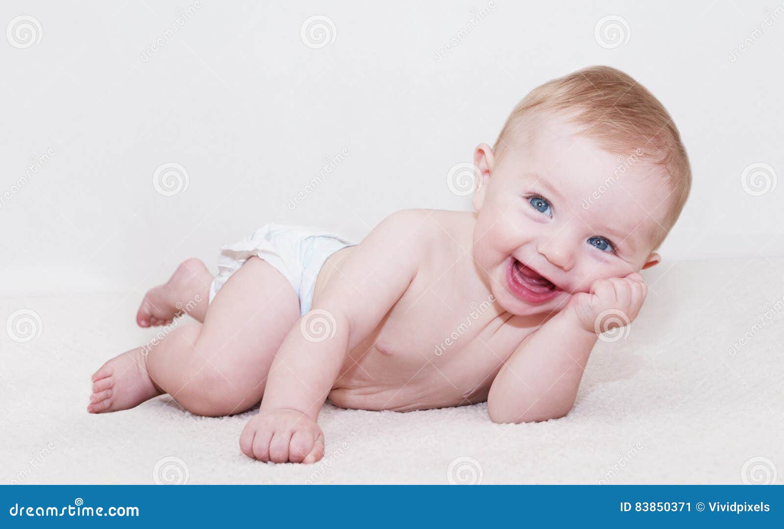 baby laying down and laughing