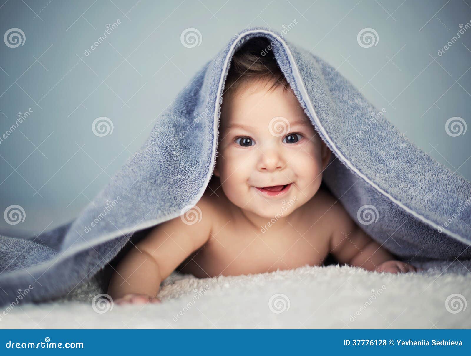 Happy Baby Girl Covered With A Blanket Stock Photo 