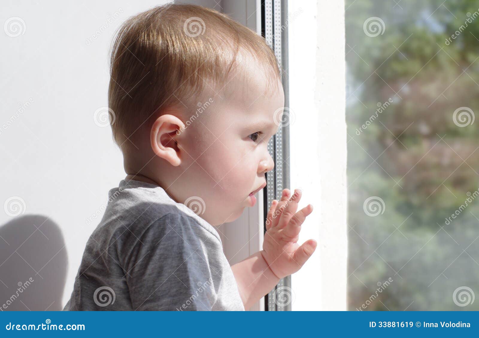 Baby looks out of window stock image. Image of wait, window 33881619