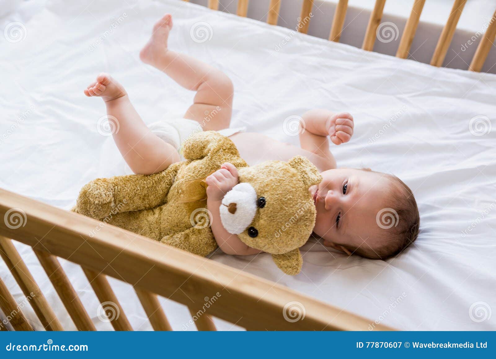 Baby lying on baby bed stock image. Image of apartment 77870607