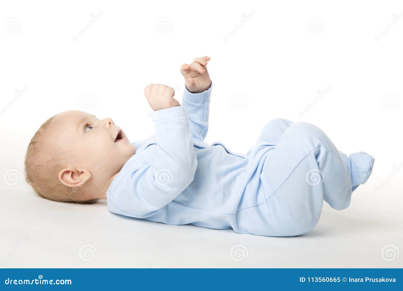 baby lying on back, happy infant kid dressed in blue bodysuit