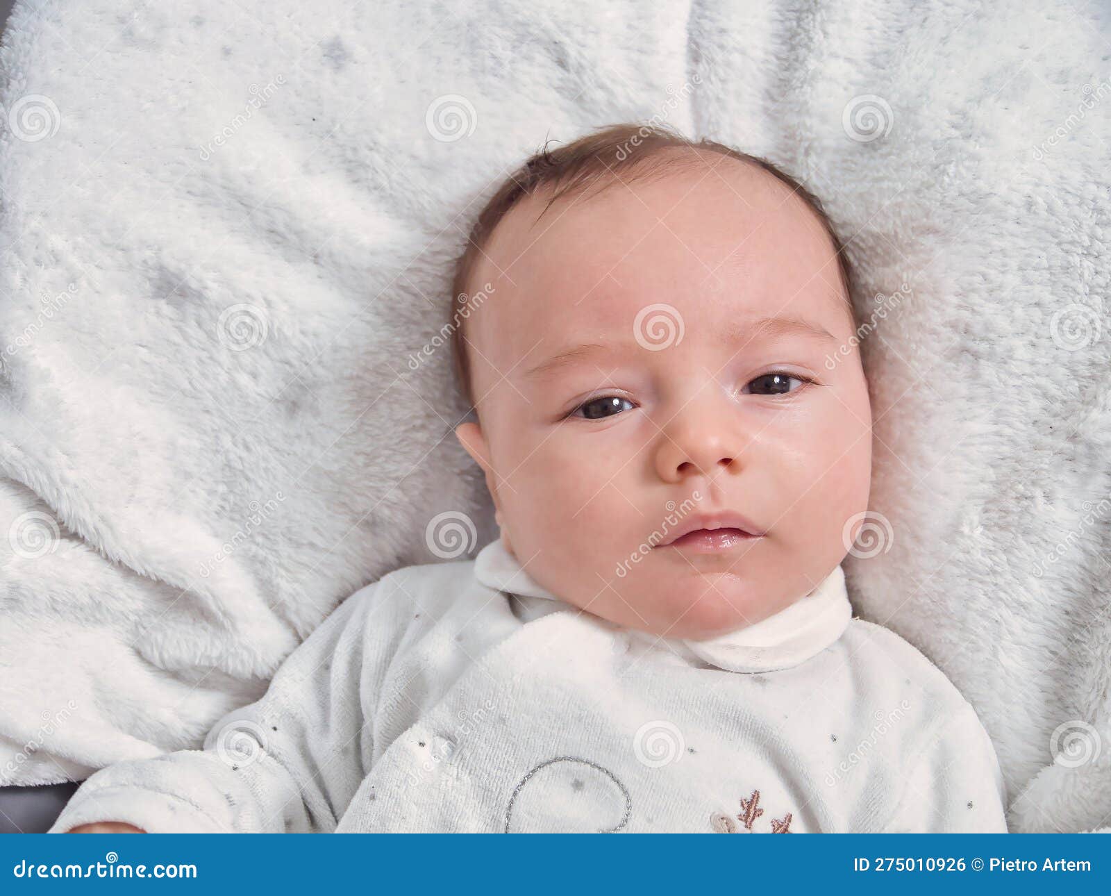 Baby, 2 Months Old, the Baby is Lying on a White Blanket, the Baby is