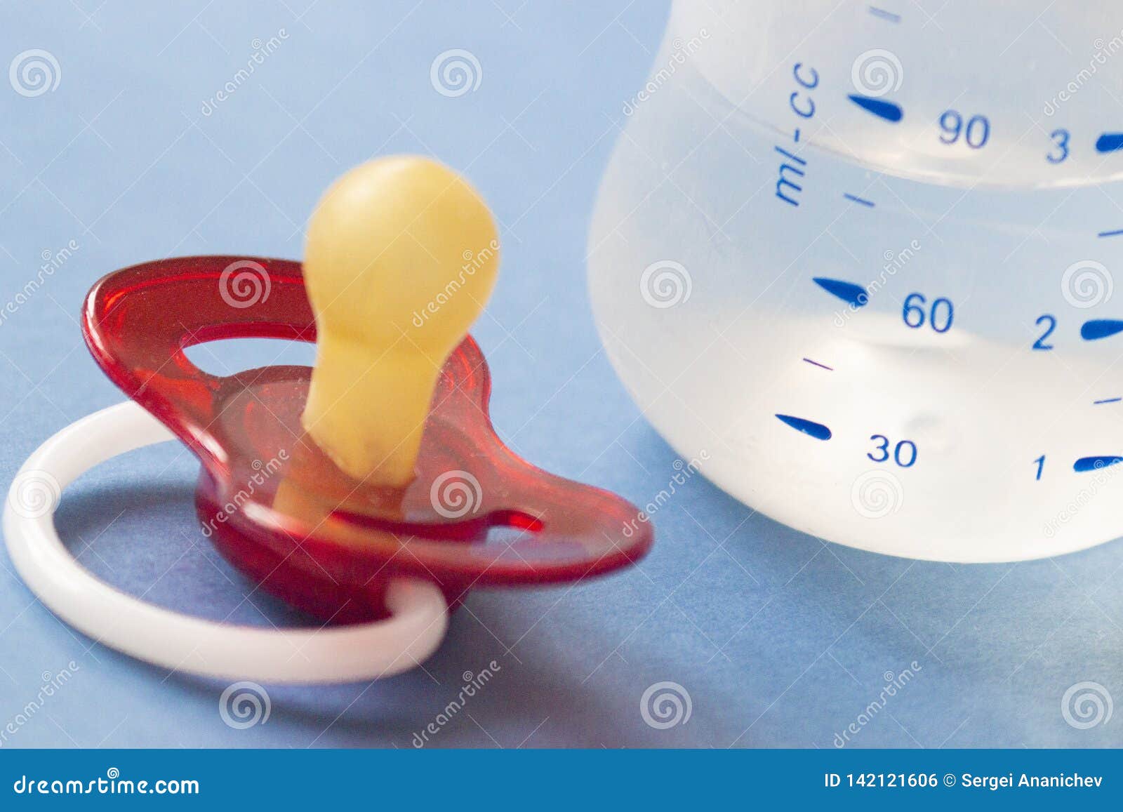 Baby Nipple with Bottle Stand on Blue Background Stock Photo - Image of ...