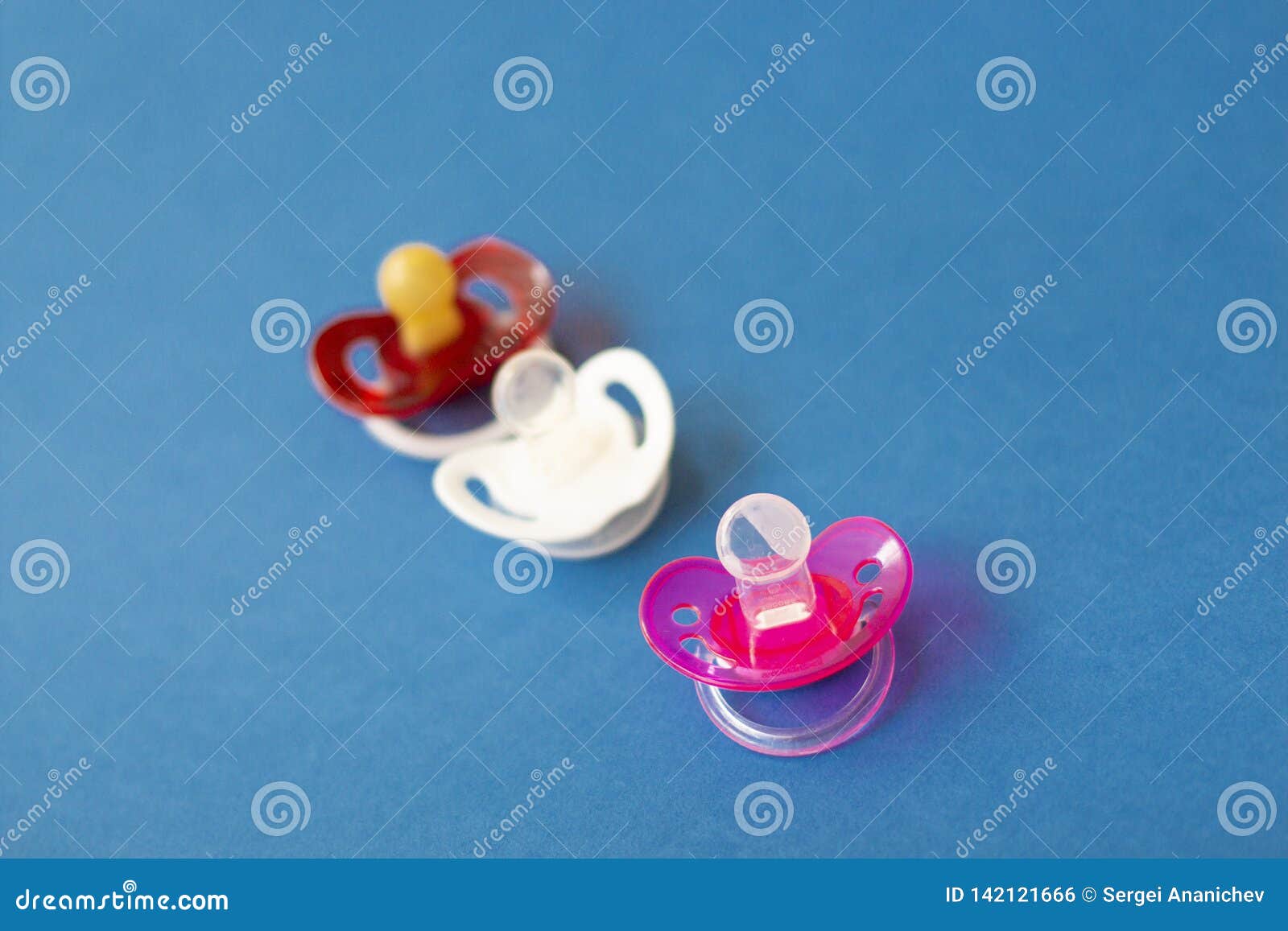 Baby Pacifiers are on a Blue Background Stock Photo - Image of pacifier ...