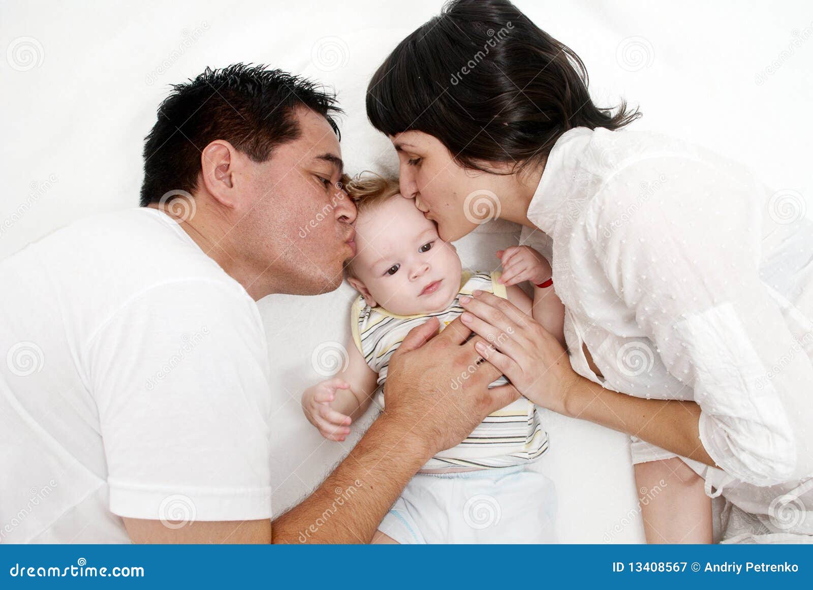 Baby with Parents Lying on a Bed Stock Image - Image of mother ...