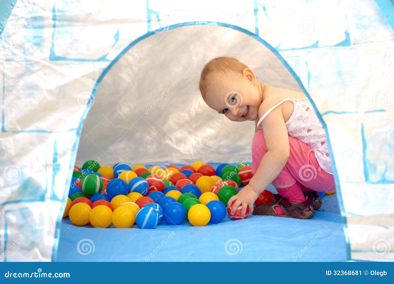 Baby playing with balls stock image. Image of sitting 32368681
