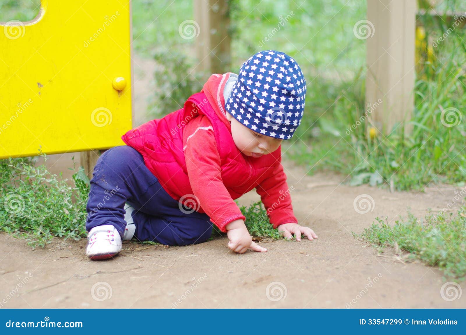 Baby Points Something Sitting on the Ground Stock Image Image of