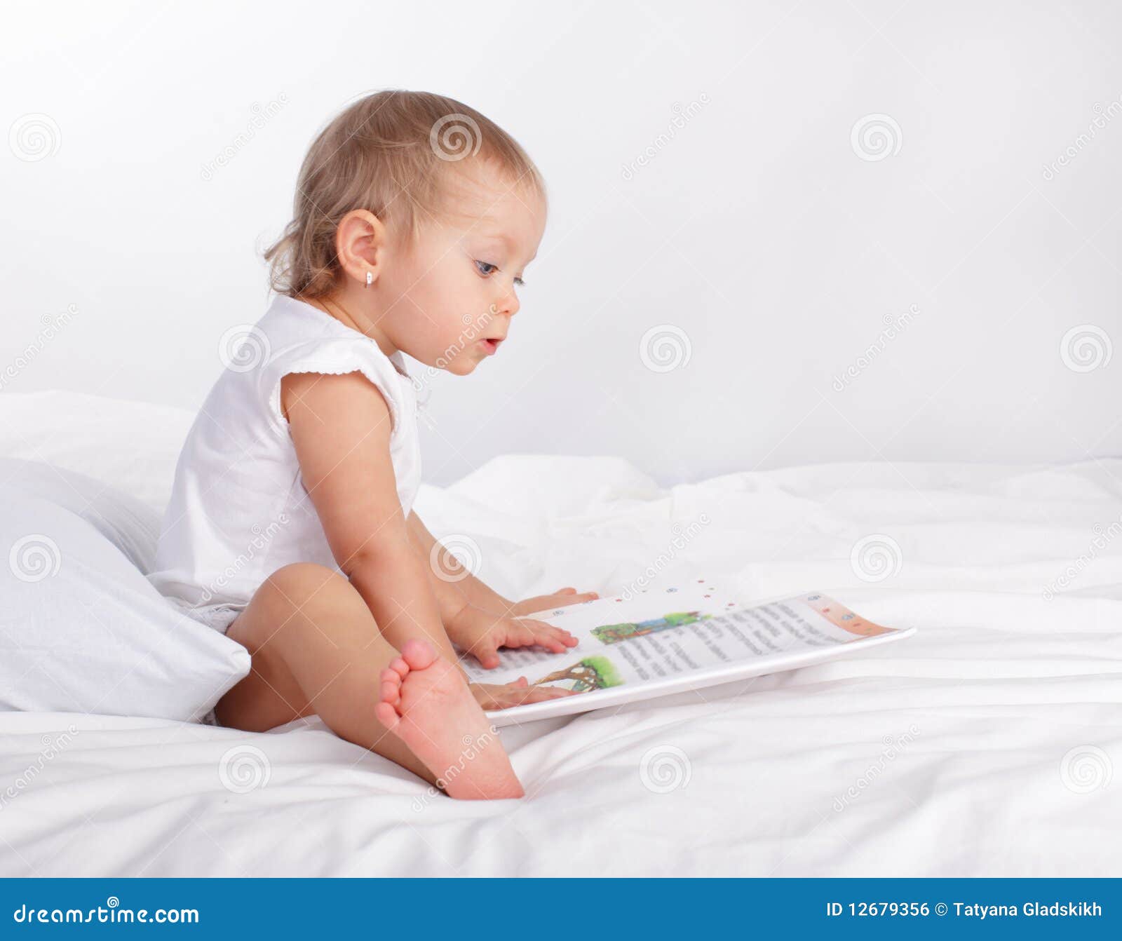 Baby reading book stock photo. Image of human, blond 12679356