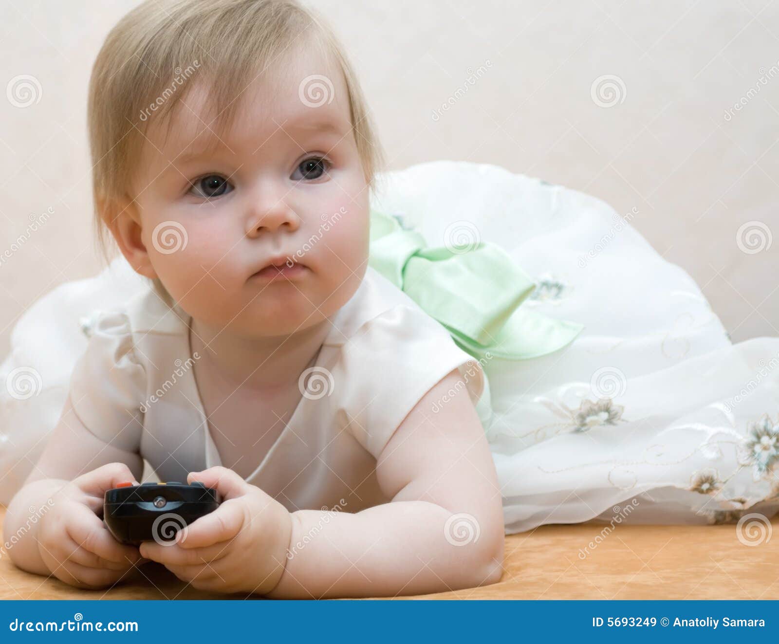 Baby with remote control stock image. Image of hand, hair 5693249