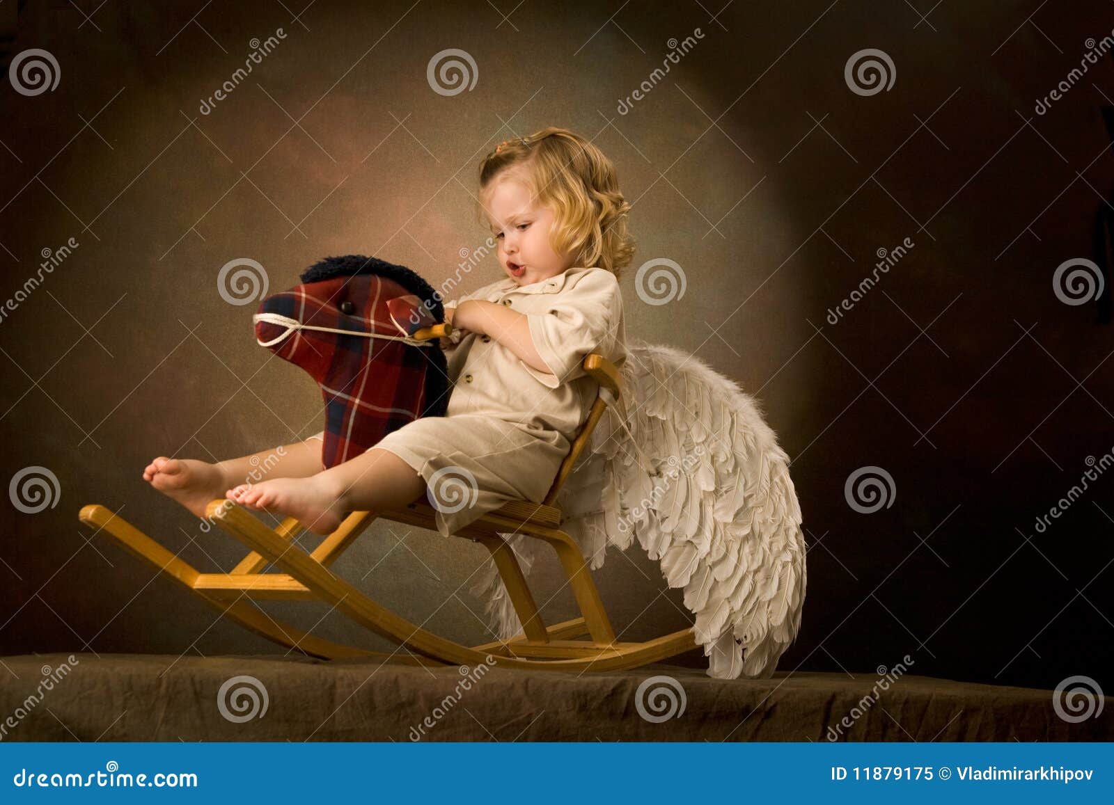 baby rides a woody horse