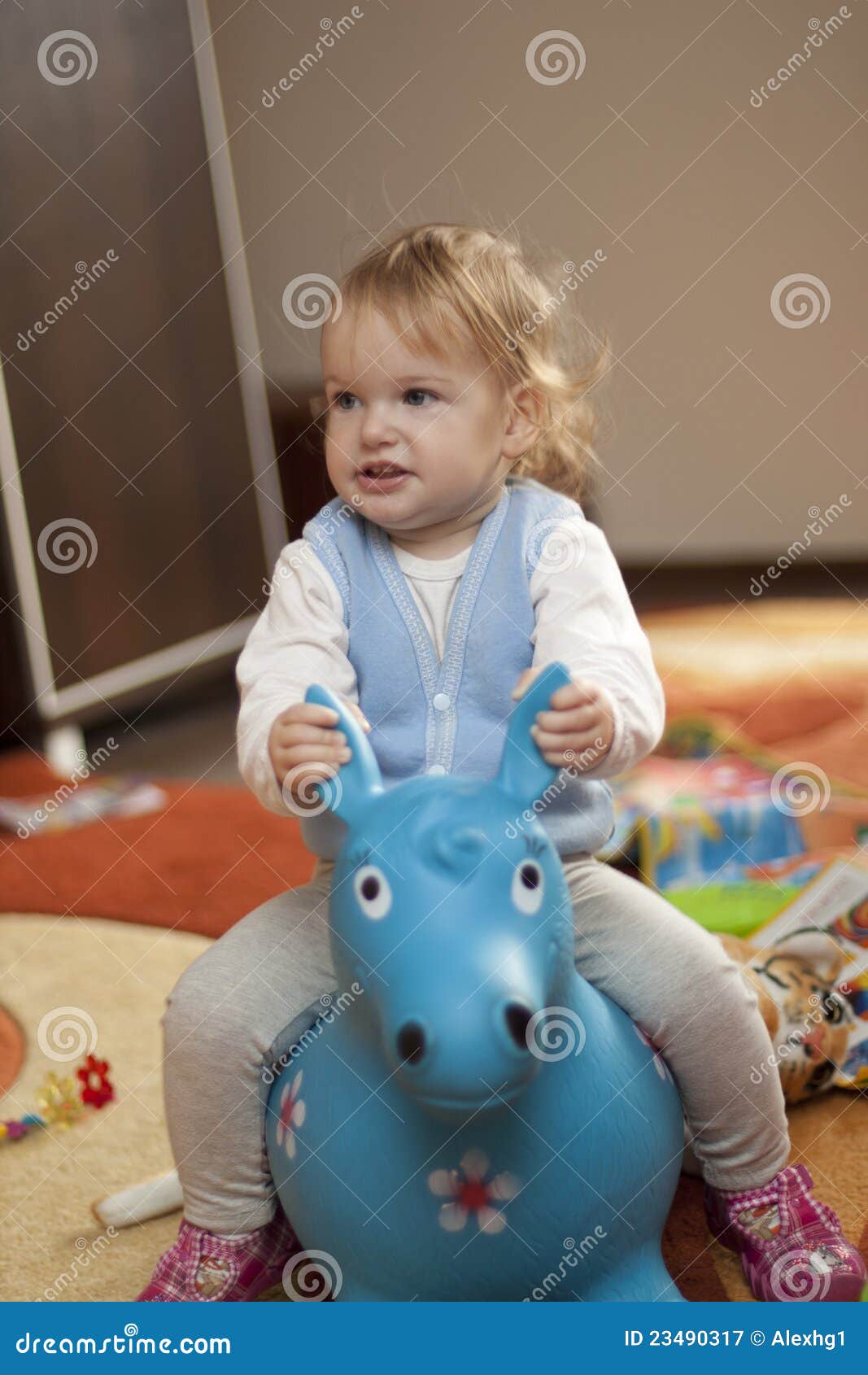 Baby riding a toy horse stock image. Image of home, soft 23490317