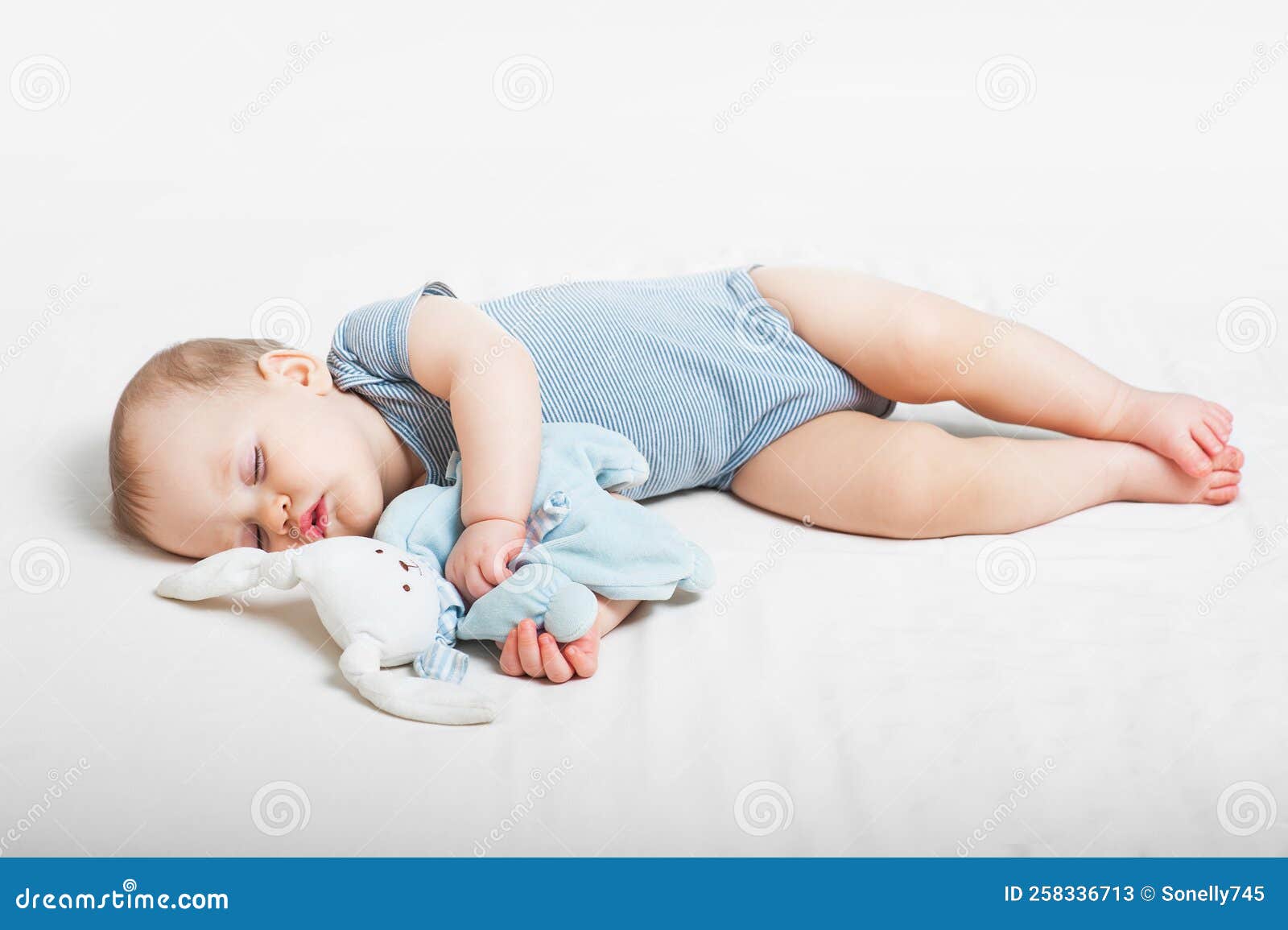 Baby Sleeps on Bed. Infant Sleeps with Toy Hare Stock Image Image of