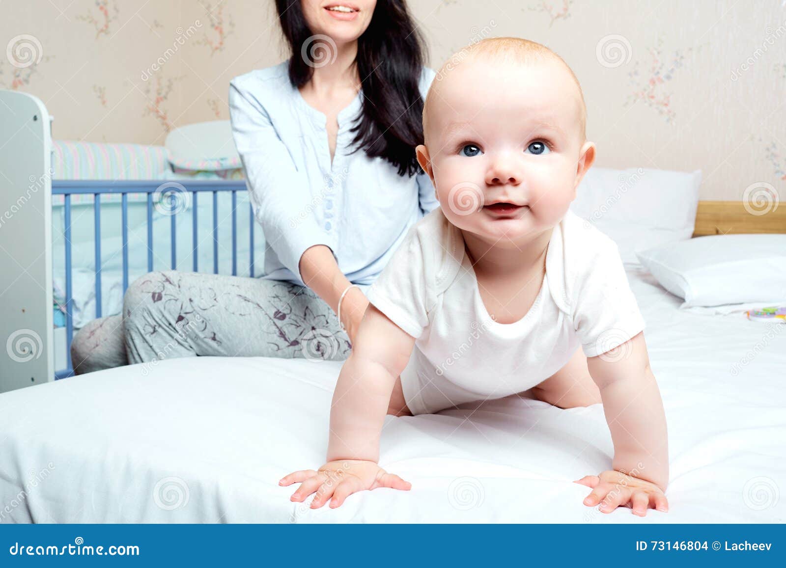 Baby with Smile Hanging Out on a Bed in a Room with Mother. the Stock ...