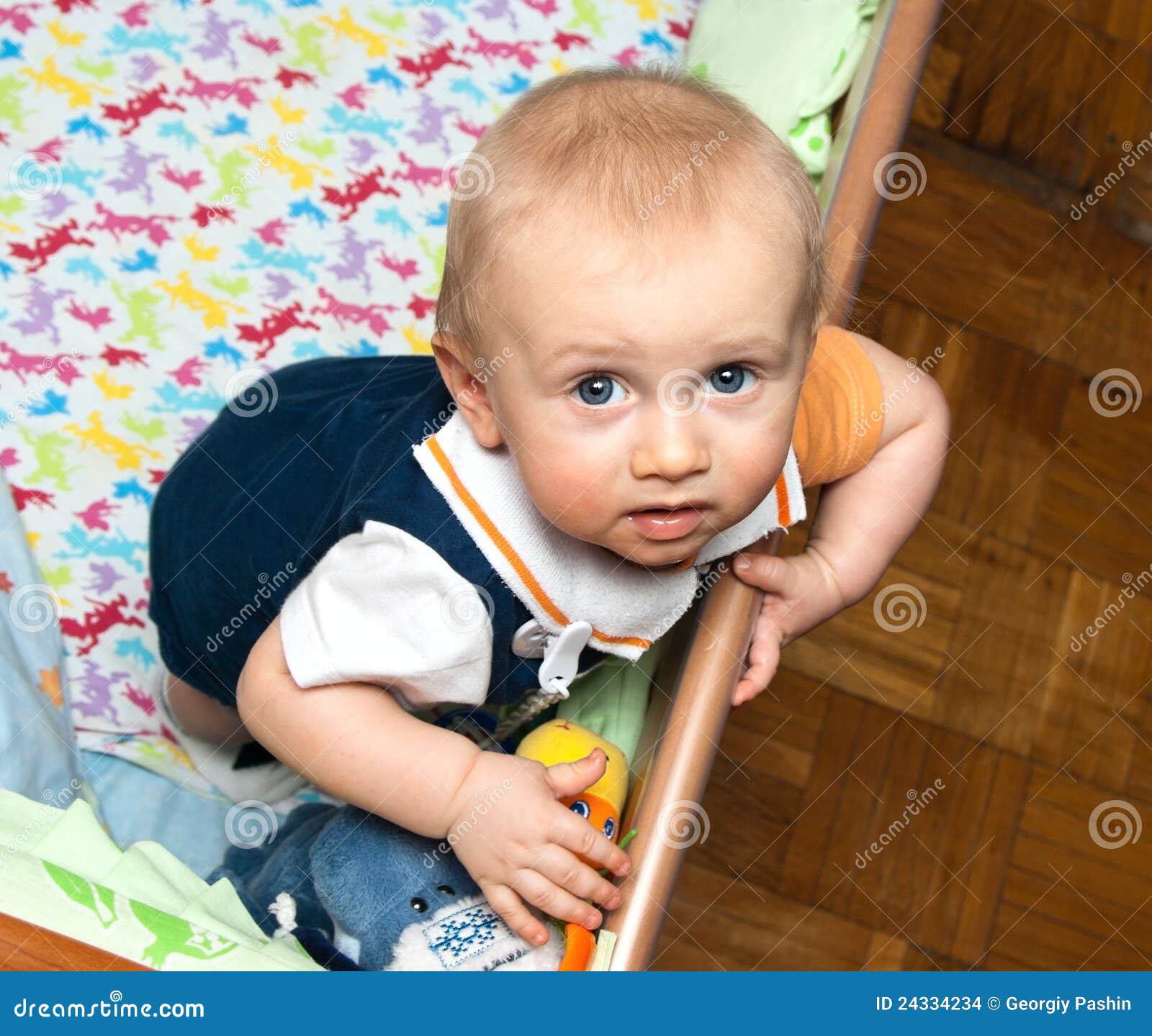 Baby standing in crib stock photo. Image of playpen, little 24334234
