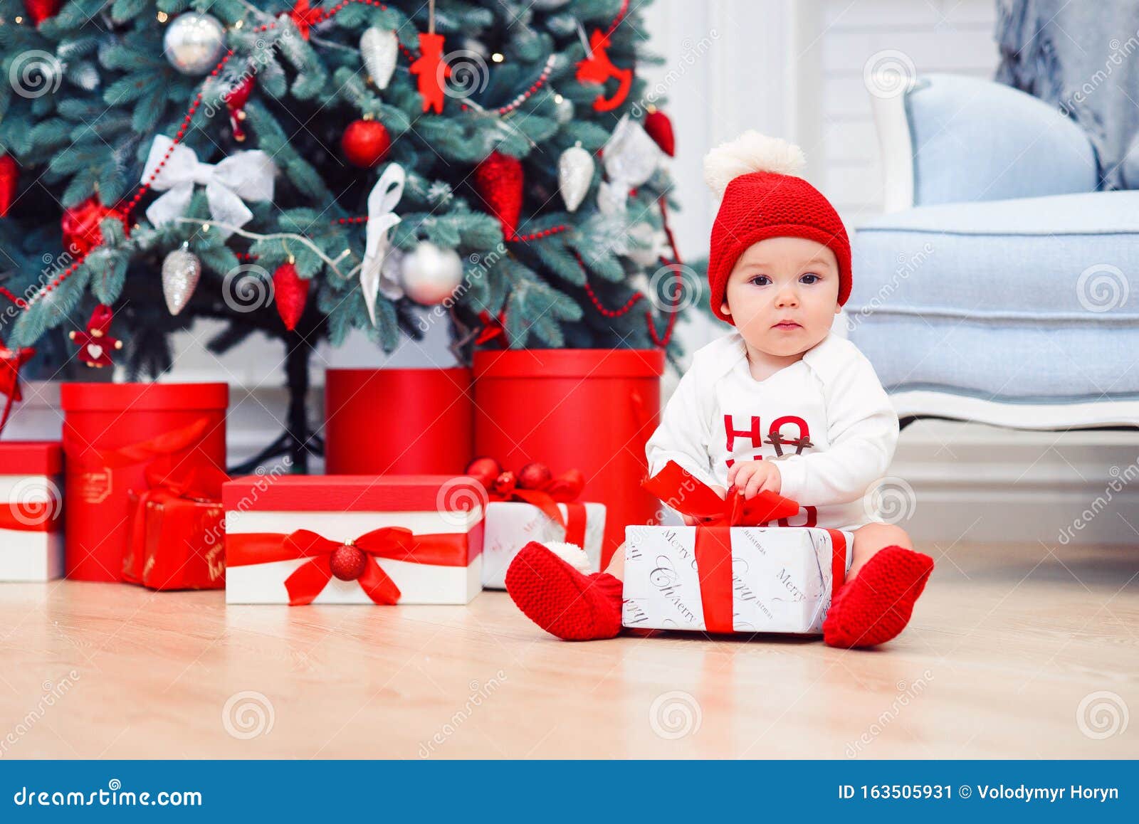Baby Unpack Gift Boxes with Christmas Decoration, Dressed As Santa ...