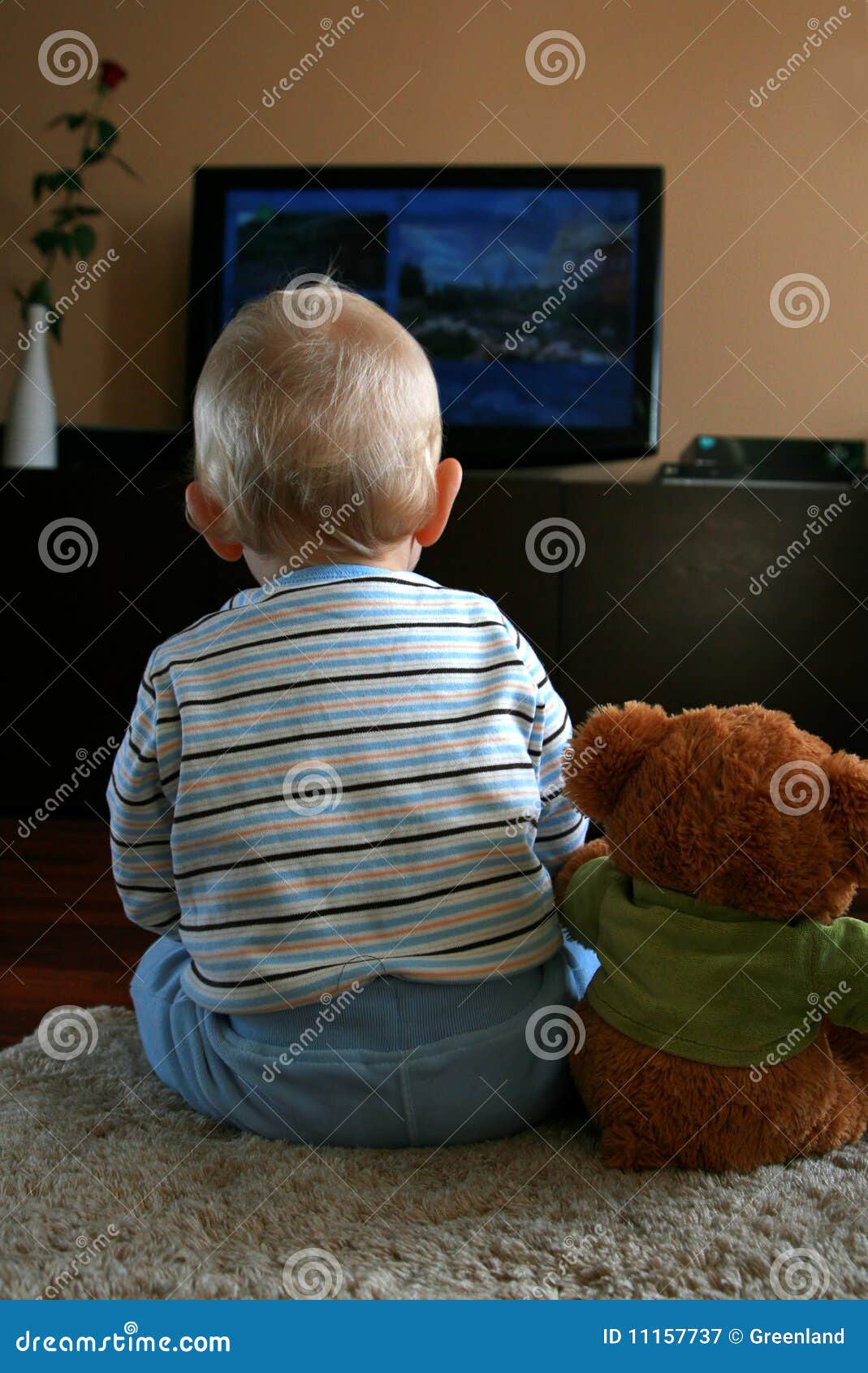 Baby watching TV stock image. Image of families, bear - 11157737