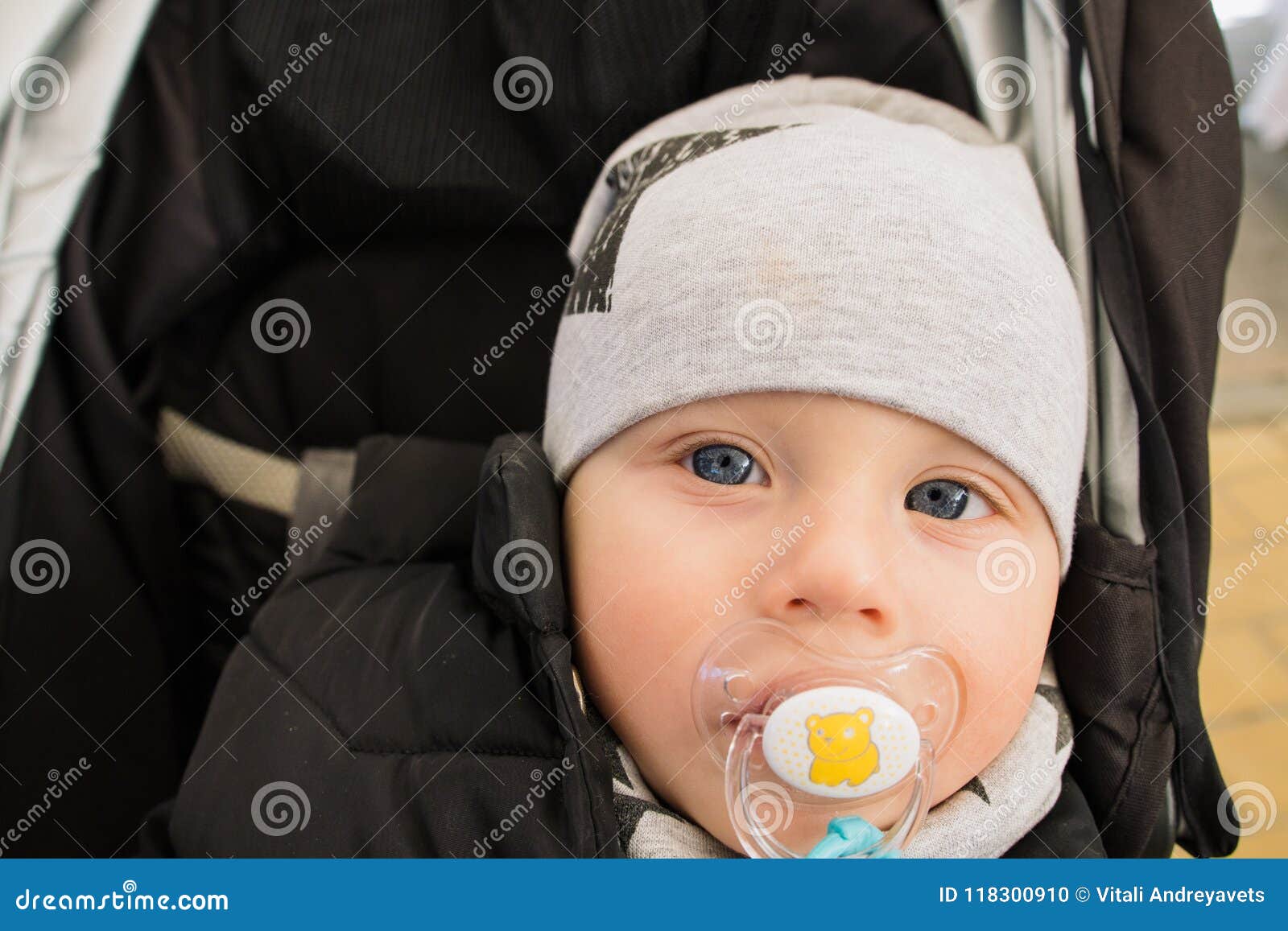 A Baby in a Wheelchair and Smiling Stock Photo Image of outdoors