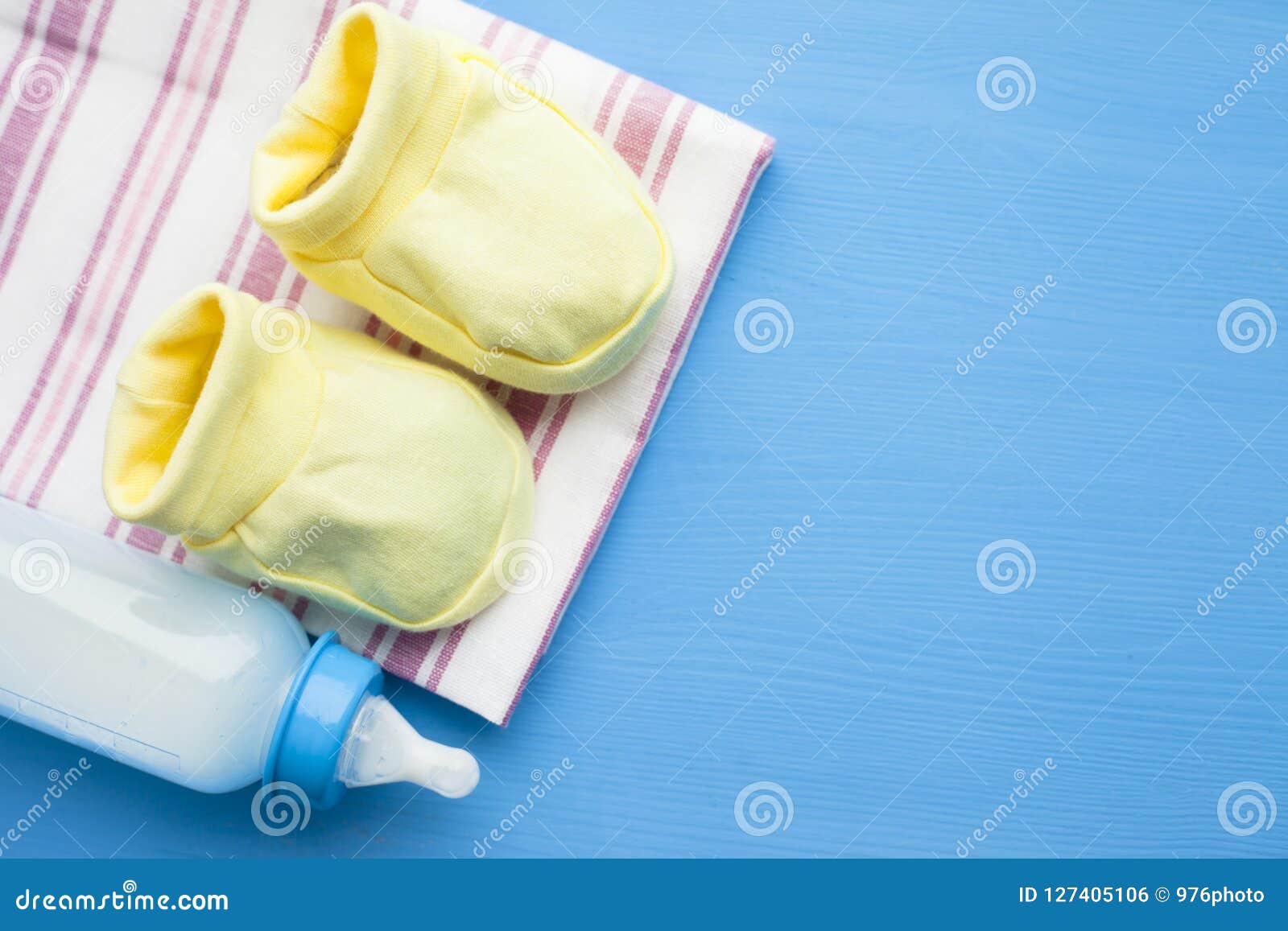 Baby Yellow Booties. Children S Shoes and Toys on Blue Background ...