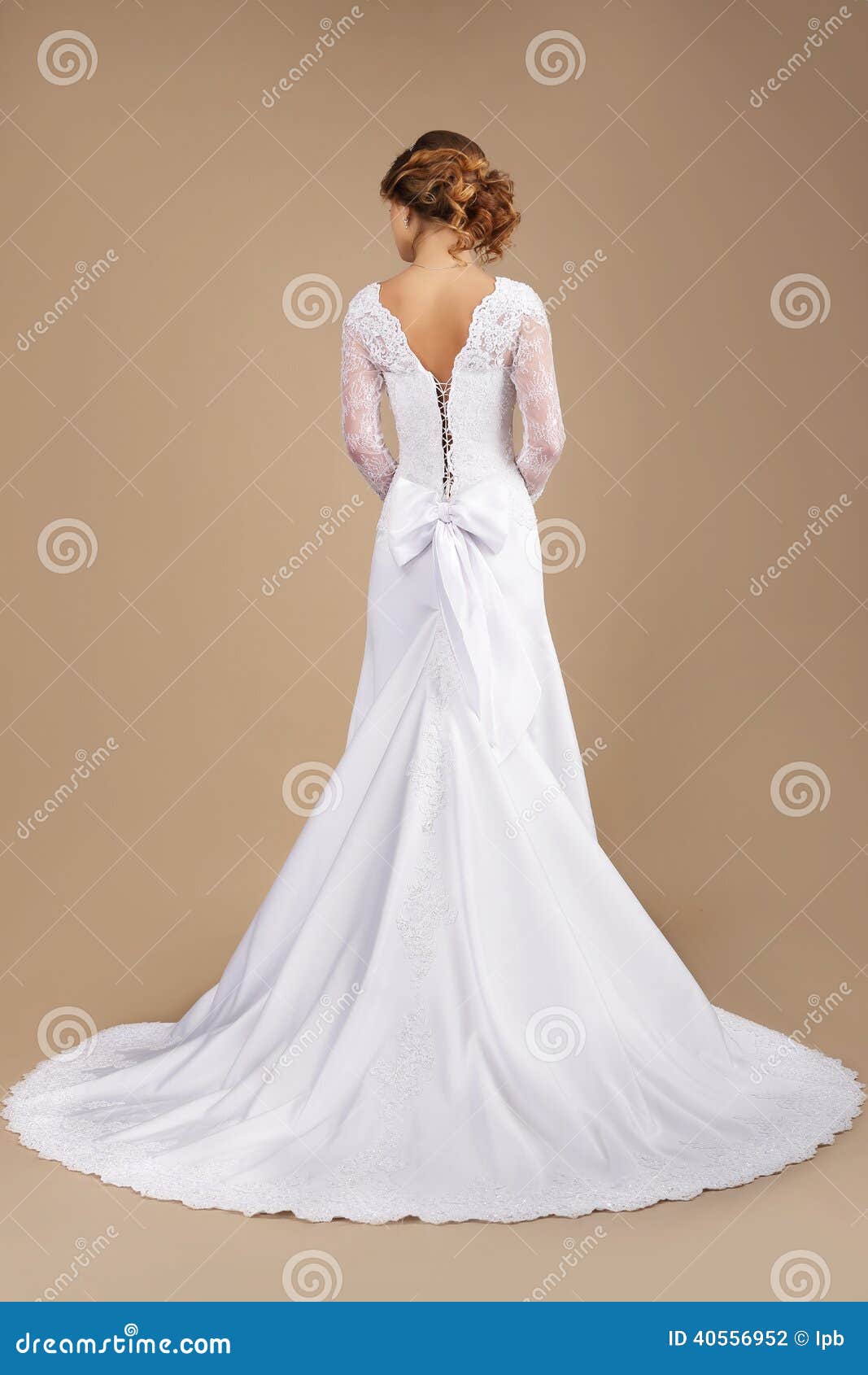back of auburn woman in long festive dress