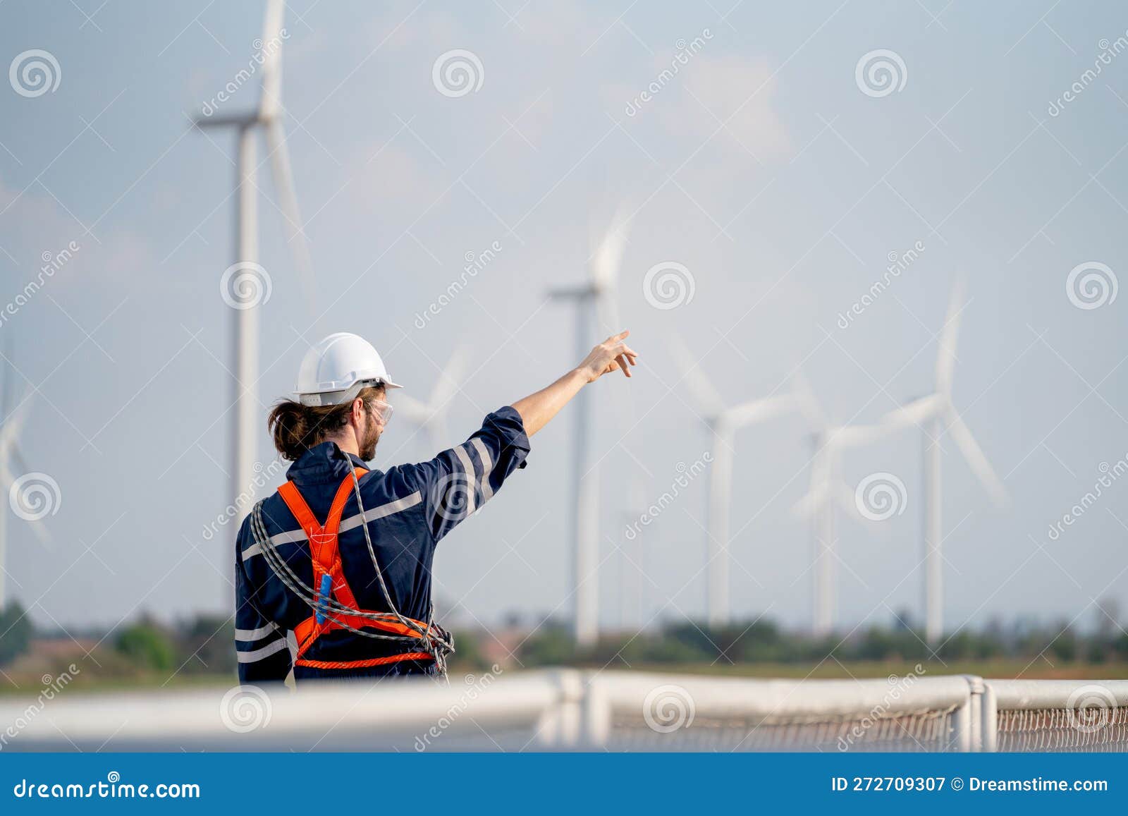 Back of Engineer or Technician Worker Point To the Field with Windmill
