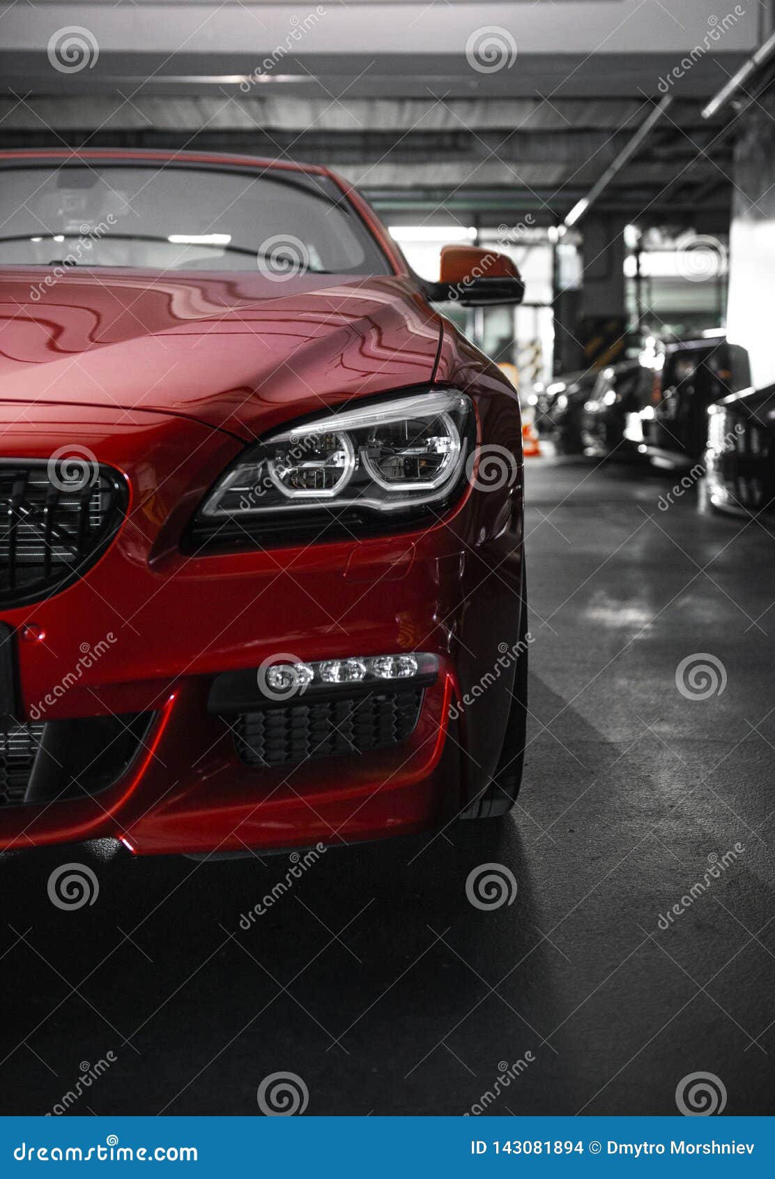 back headlight of a modern luxury red car, auto detail, car care concept in the garage