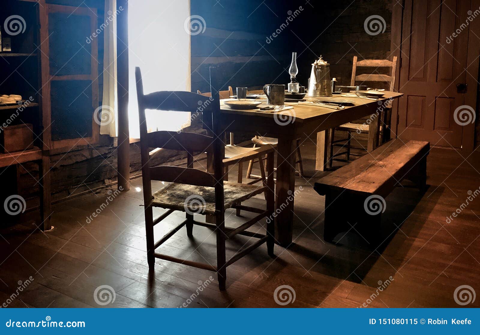 Back Lit Interior Of A Rustic Farmhouse Dining Room Stock Image