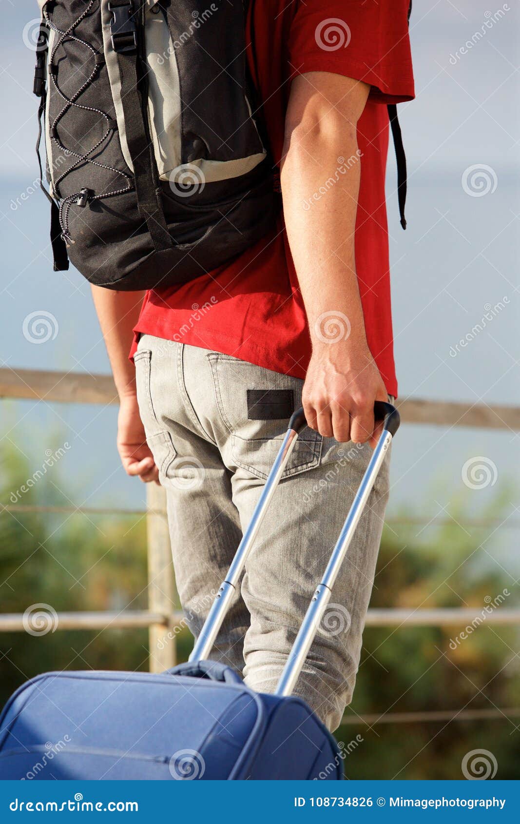 Man Walking with Backpack and Pulling Suitcase Stock Photo Image of