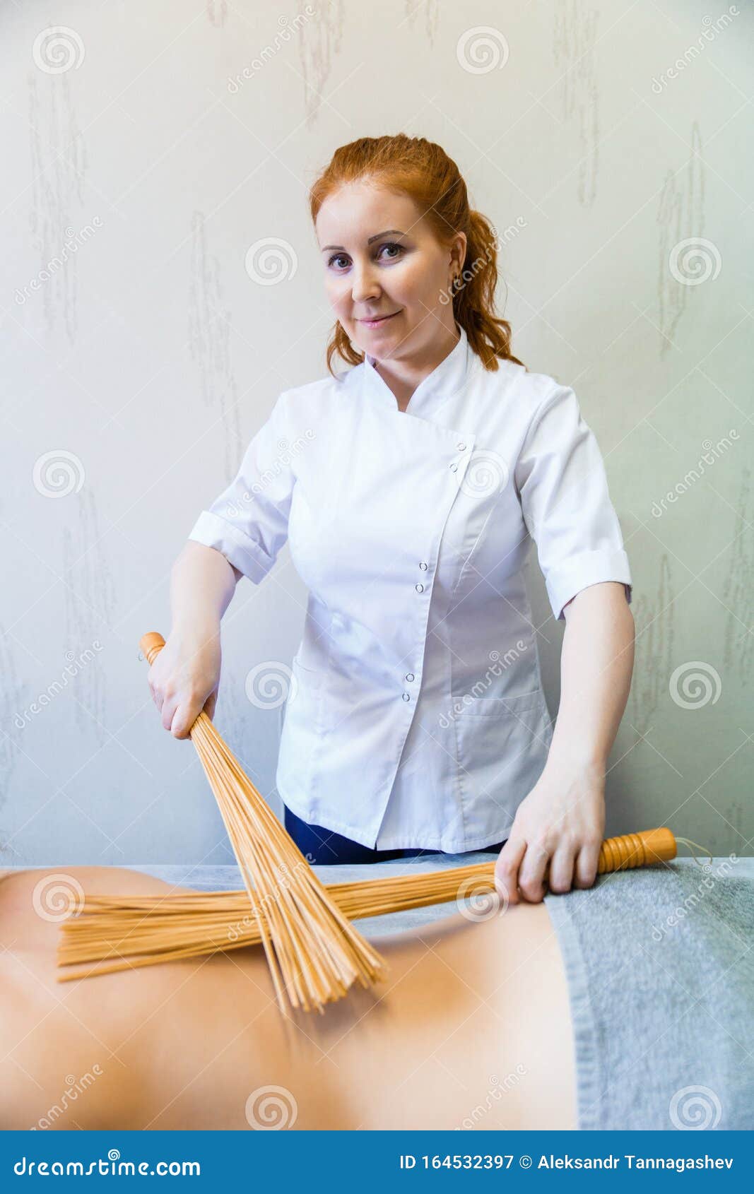 Back Massage In The Massage Room With Bamboo Brooms Massage Therapist