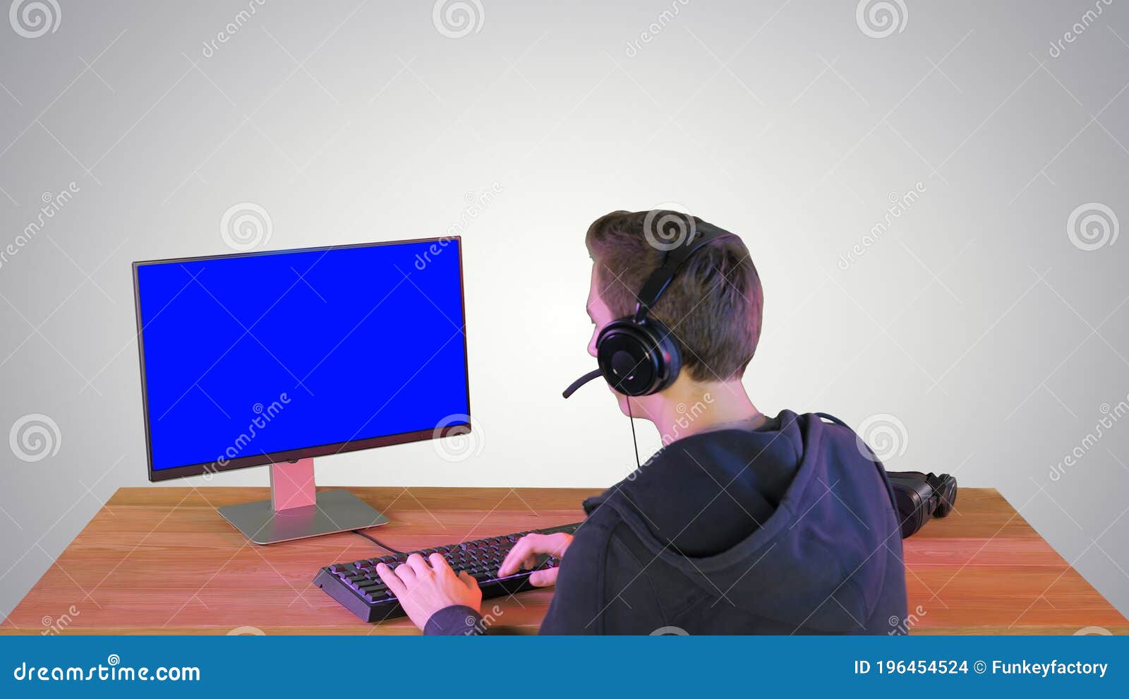 Back shot of pro gamer playing online shooter game on computer using  wireless controller. Competitive player man winning videogame tournament  use professional equipment at home gamming studio Stock Photo - Alamy