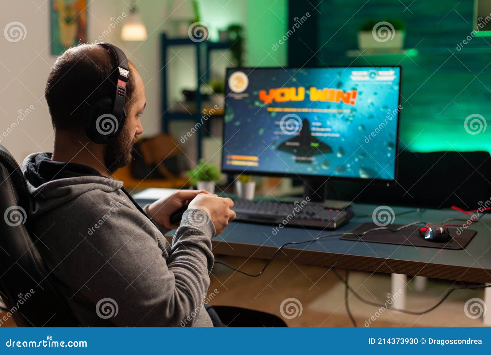 Back Shot of Pro Gamer Playing Online Shooter Game Stock Photo