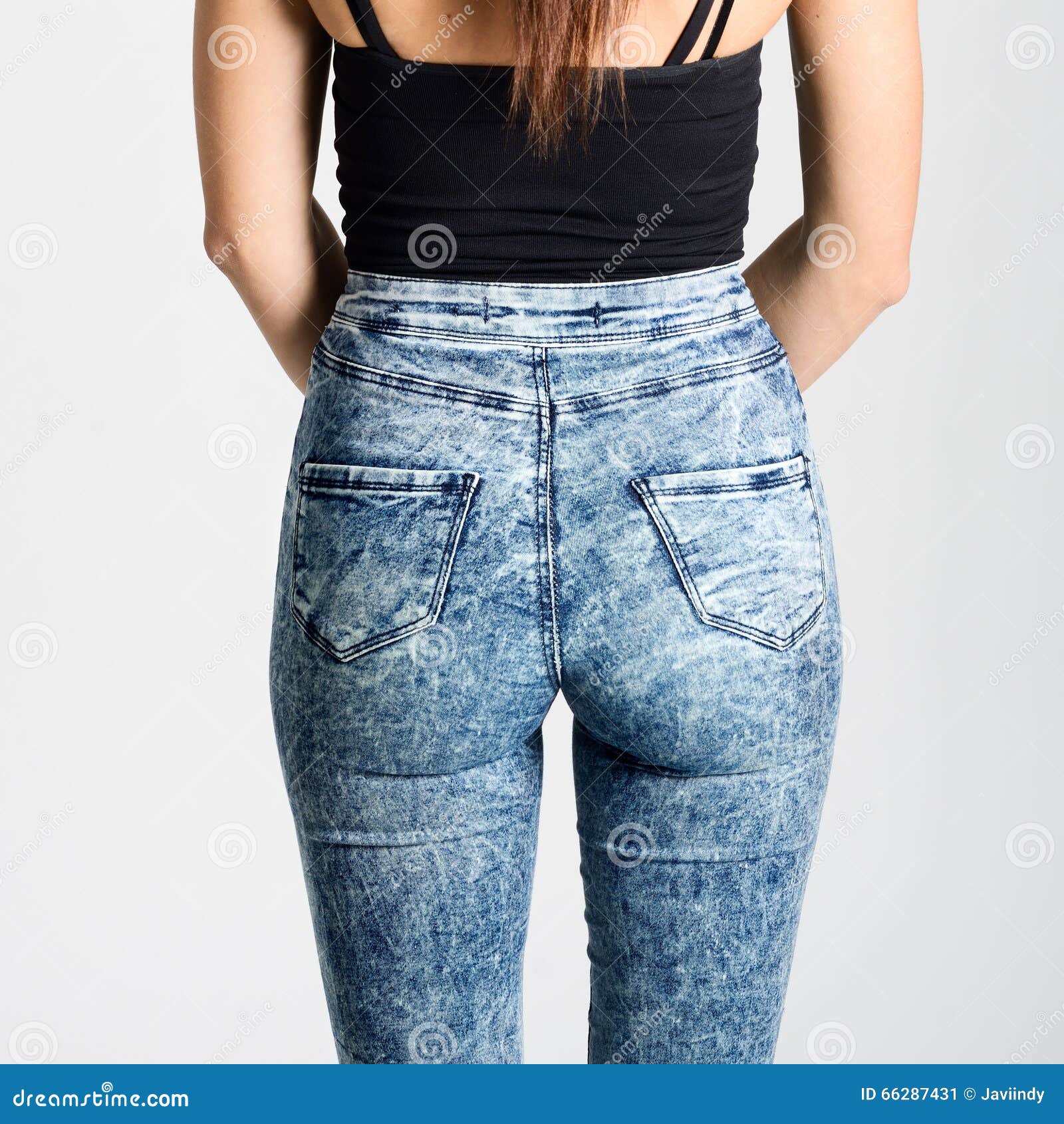 back side of woman wearing high-waisted jeans