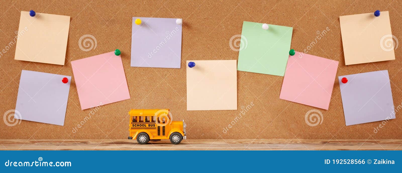 back to school and education concept. school bus toy with colorful notes for  on wooden background